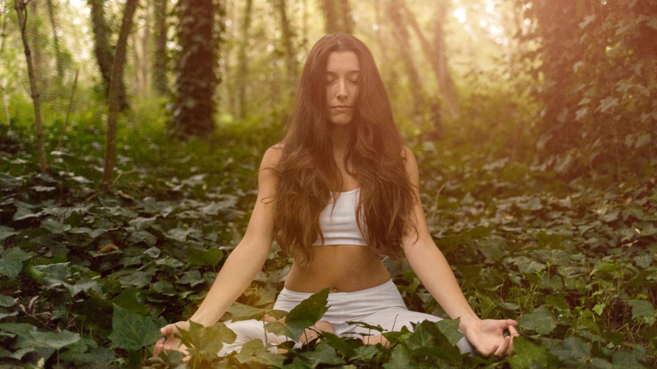 Call woman sitting in a relaxed pose, chanting and embodying peace and mindfulness.